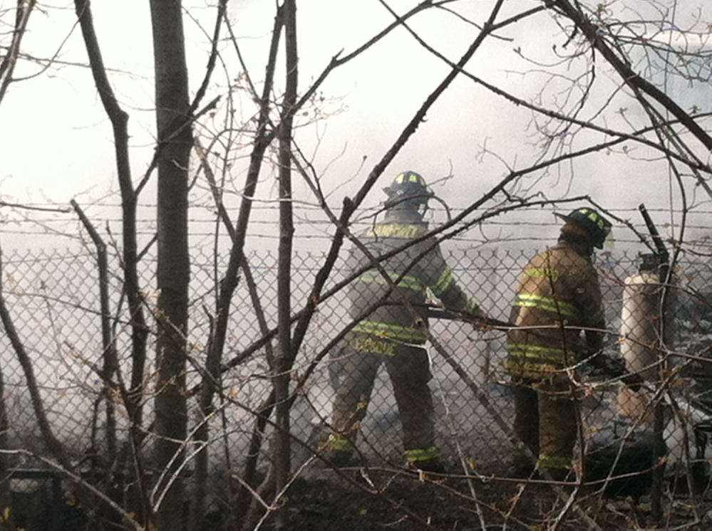 Firefighters engulfed by smoke work to extinguish a fire in Old Orchard Beach last week.