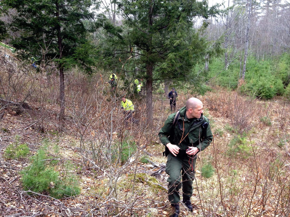 Led by Maine Game Warden Troy Thibodeau, EMTs, firefighters, game wardens and volunteers search for Jaden Dremsa along Route 5 in North Waterboro on Friday.