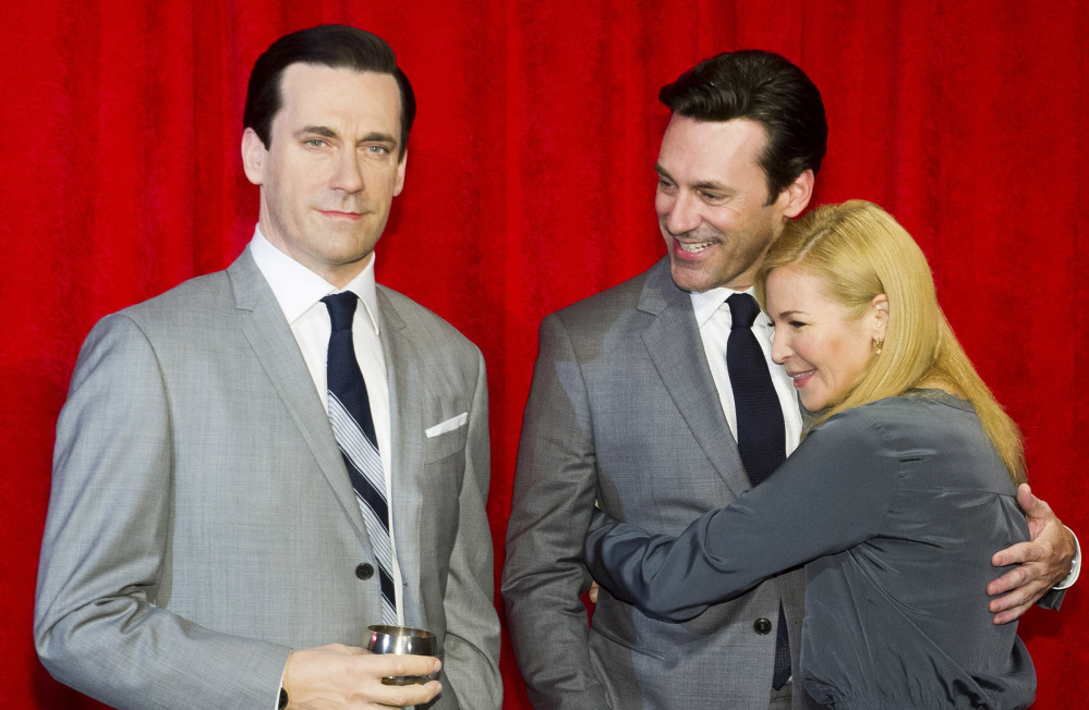 Jon Hamm and his girlfriend, Jennifer Westfeldt, embrace at the unveiling of his wax figure Friday in New York.