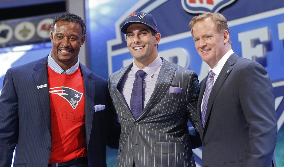Eastern Illinois quarterback Jimmy Garoppolo poses for photos with NFL commissioner Roger Goodell and former New England Patriots linebacker Willie McGinest after being selected as the 62nd pick by the New England Patriots in the second round of the 2014 NFL draft on Friday.