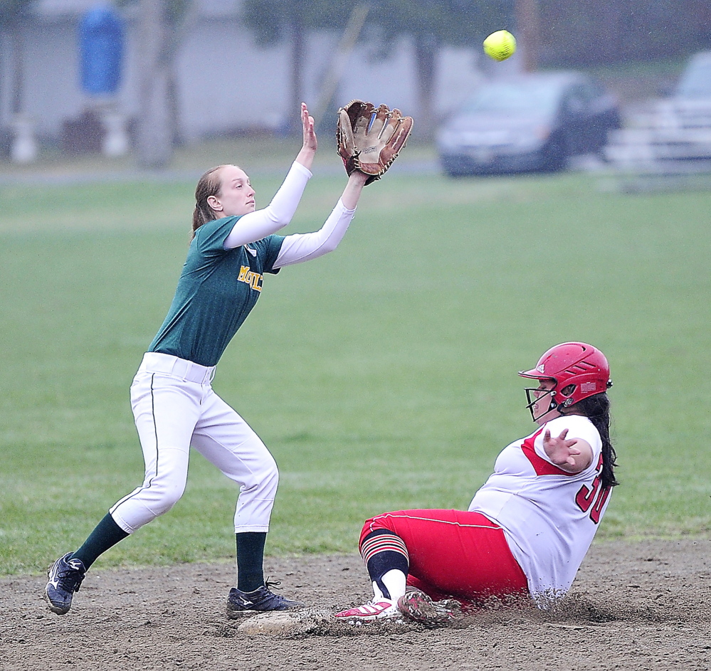 Kaitlin Bouchard of South Portland slides safely into second base Friday as Taylor Whaley of McAuley waits for a high throw from home plate during their SMAA softball game in Portland. South Portland won 9-7 on Olivia Indorf’s three-run homer in the seventh inning.
