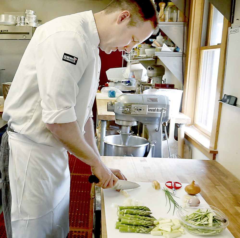 Joshua Mather, chef and owner of Joshua’s Restaurant and Bar, preps the vegetables for asparagus soup.