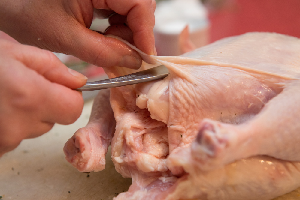 Shaw's purchased chicken having skin loosened to place butter under skin