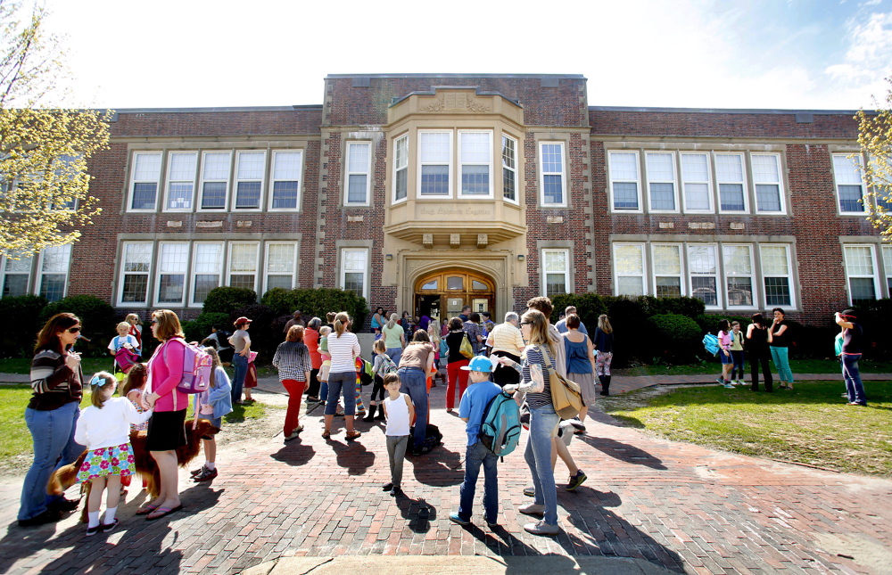 Students gather in front of Longfellow Elementary School in Portland at the end of a school day last May.