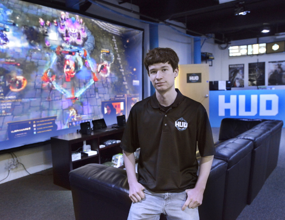 Gabe Letourneau, 18, stands in the HUD Gaming Lounge in Biddeford, which is bathed in blue light and lined with custom-built gaming PCs. He hopes to tap into the popularity of competitive gaming in the U.S. and eventually expand into areas outside of southern Maine.
