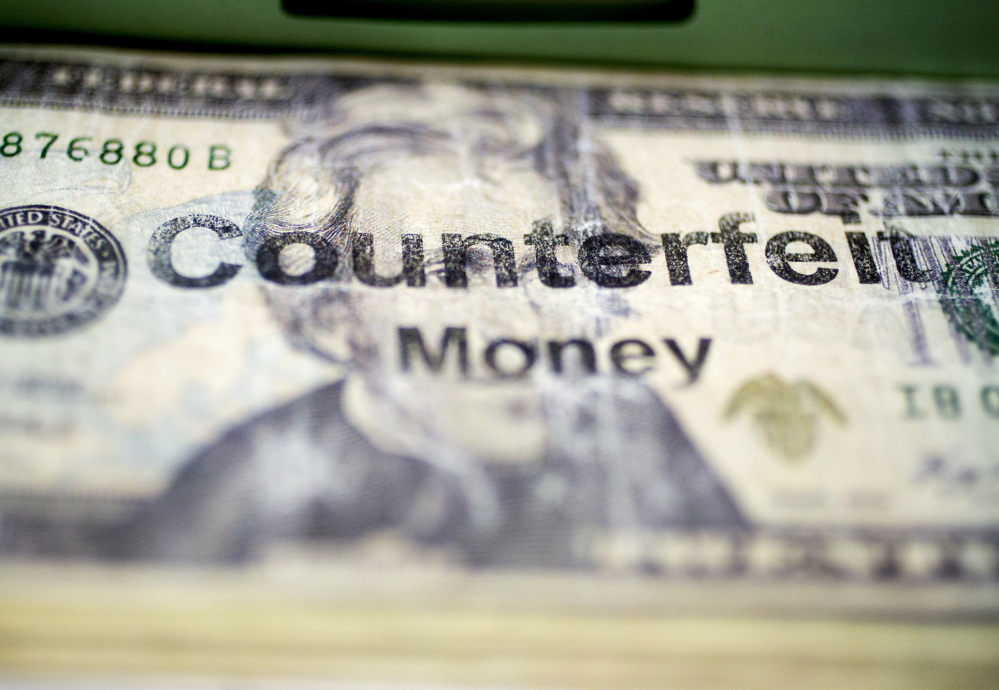 A counterfeit $20 bill sits in the counterfeit specimen vault at Secret Service headquarters in Washington, D.C.