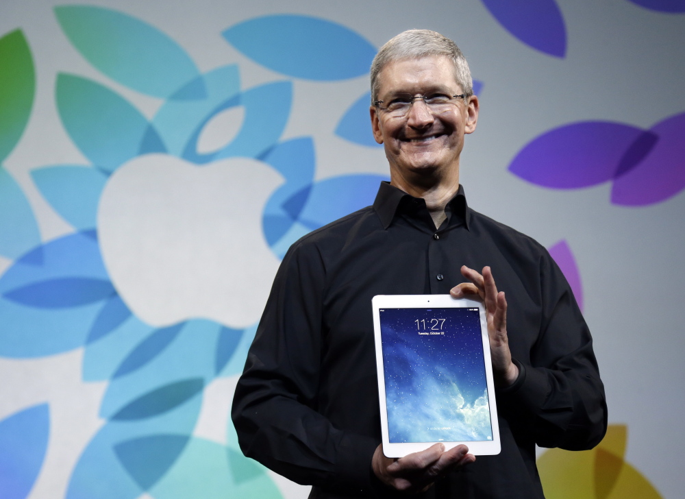 Apple CEO Tim Cook introduces the new iPad Air in 2013. Unlike Apple co-founder Steve Jobs, Cook appears willing to spend on acquisitions – reportedly such as Beats Electronics.