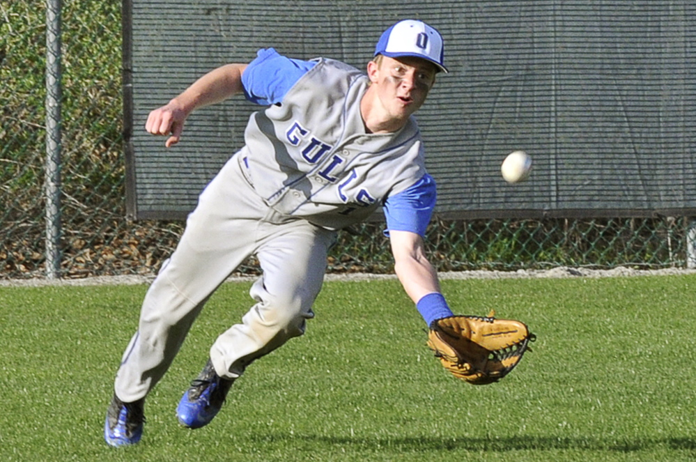 Tyler Scott of Old Orchard Beach heads to the ground to make a catch in center field Monday during Waynflete’s 10-9 victory in a Western Maine Conference game at Portland.