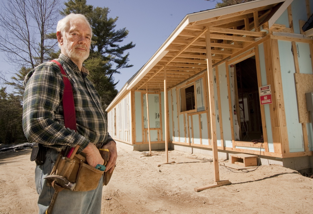 Robert Howe stands outside the energy-efficient, net-zero home he is having built in Brunswick. The home is designed to create as much energy as it consumes.