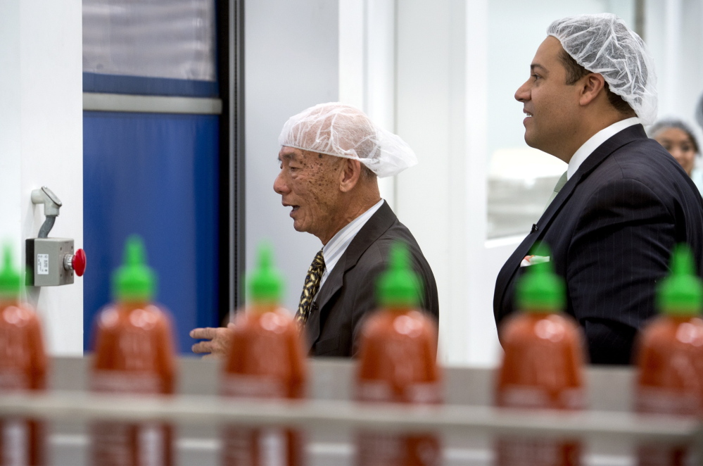 Texas state Rep. Jason Villalba, right, tours the Huy Fong Foods plant, maker of Sriracha hot sauce, with founder and CEO David Tran, in Irwindale, Calif., on Monday.