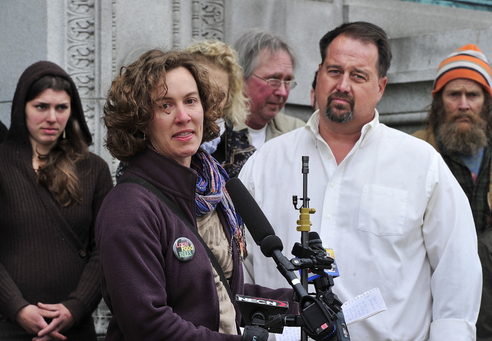 Heather Retberg, a farmer and founding member of Local Food RULES, addresses the media as she stands next to farmer Dan Brown during a rally prior to his case being heard by the Maine Supreme Judicial Court in Portland on Tuesday.