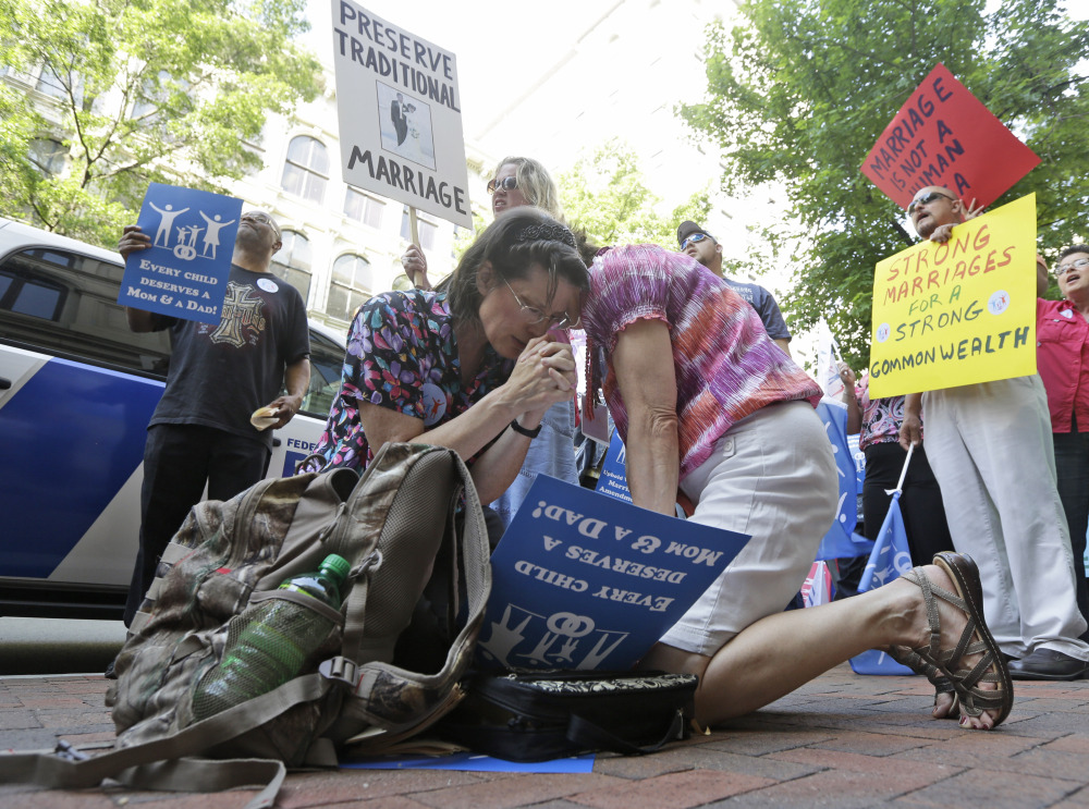 Members of the Family Foundation and supporters of traditional marriage pray outside the Federal Appeals Court in Richmond, Va., on Tuesday.
