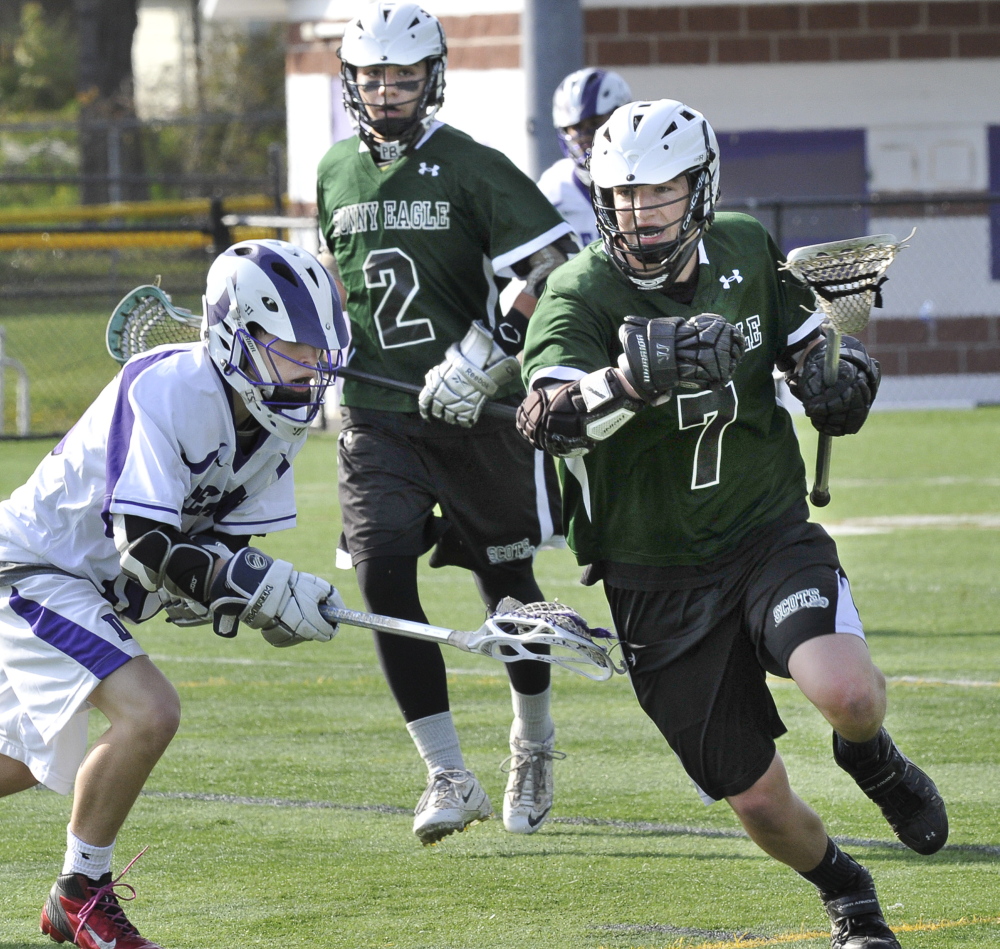 Zack Gryskwicz of Bonny Eagle looks for a way to get past Isaac Santerre of Deering during their high school lacrosse game Wednesday. Deering pulled away to a 16-6 victory at Portland.