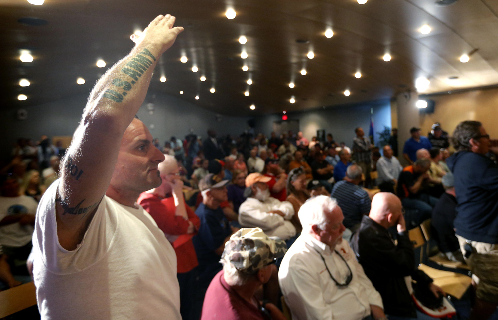 Veteran Mark Howey waits to ask a question as Sen. John McCain speaks during a forum with veterans regarding lapses in care at the Phoenix Veterans Affairs hospital, on Friday, in Phoenix.