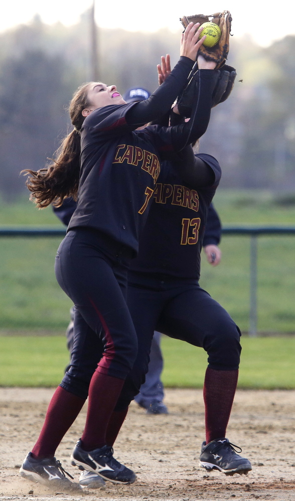 Emma O’Rourke of Cape Elizabeth makes a catch to end the fourth inning Wednesday while avoiding a collision with teammate Ashley Tinsman. The Capers defeated Greely, 12-3.