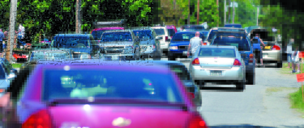 Traffic is at a near standstill at the annual 10-mile yard sale running from Cornville to Skowhegan in May 2012. Police say they will not hesitate to tow cars that are blocking roads during this year’s sale this weekend.