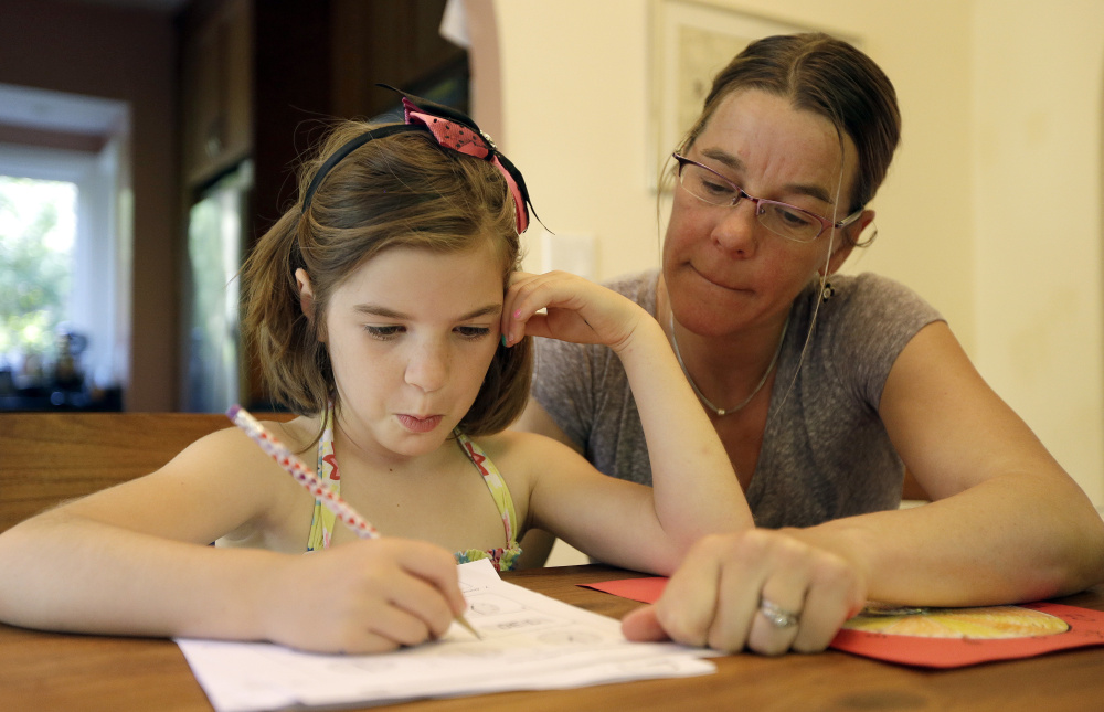 Stacey Jacobson-Francis works on math homework with her 6-year-old daughter, Luci, on Wednesday at their home in Berkeley, Calif. As schools implement national Common Core learning standards, parents say that grade-school math has become as complicated as calculus.
