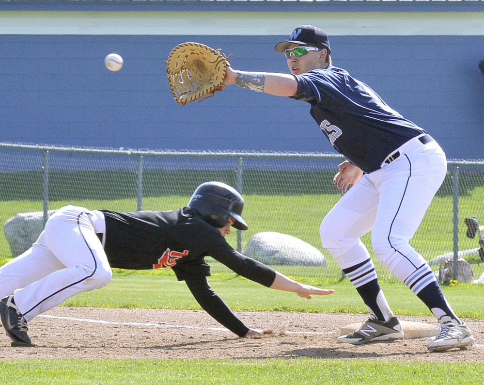 Corey Creeger of Biddeford dives back as first baseman D.J. Henrikson of Westbrook collects the throw on a pickoff attempt Thursday during Biddeford’s 7-1 victory. Creeger was the winning pitcher, allowing four hits and striking out seven.