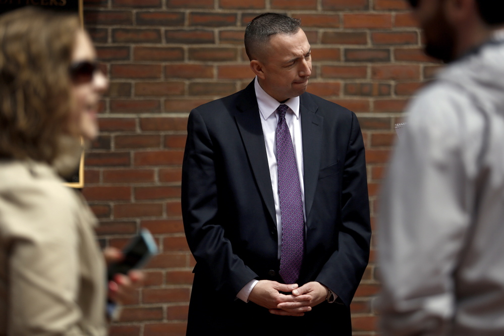 Portland Police Chief Michael Sauschuck talks with a reporter Tuesday after a news conference. He said that a national newspaper’s report that the city is home to three violent rival gangs is wildly exaggerated.