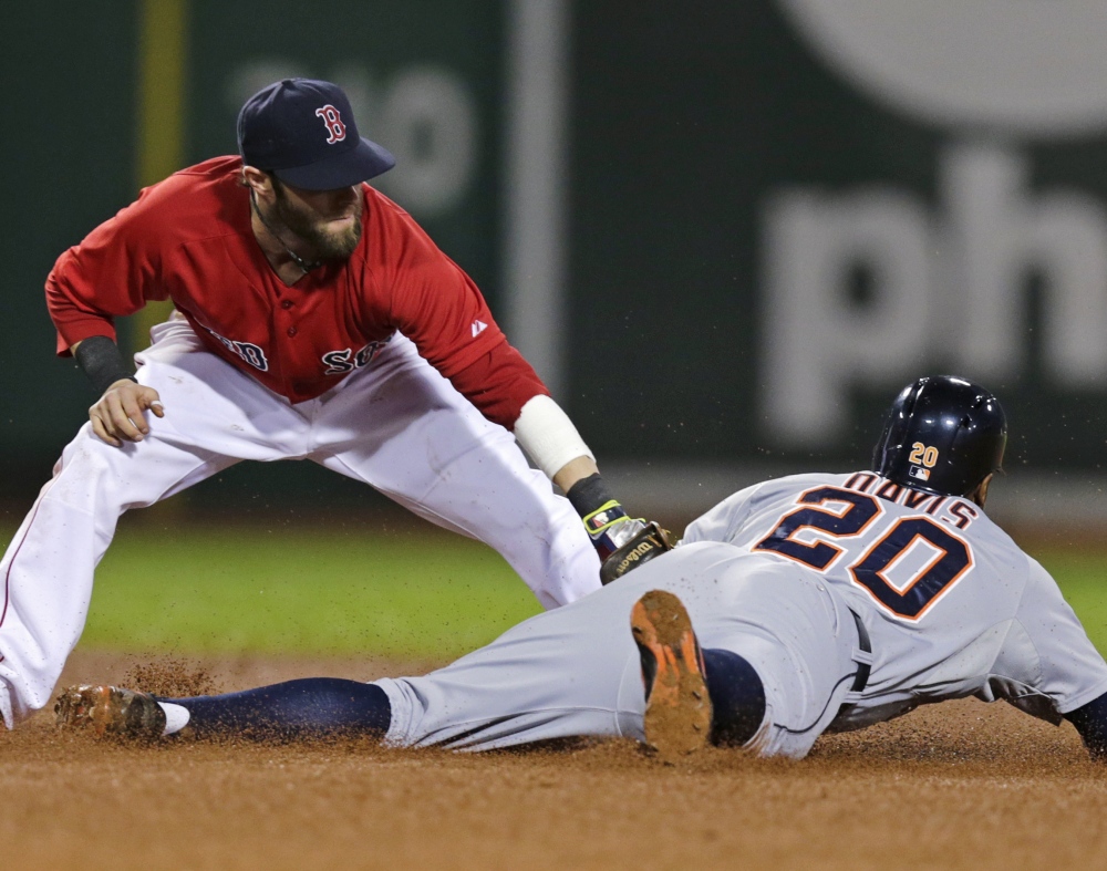 Detroit’s Rajai Davis steals second base while the ball gets away from Boston infielder Dustin Pedroia during the fifth inning of the Tigers’ 1-0 victory during a rain-delayed game at Fenway Park.