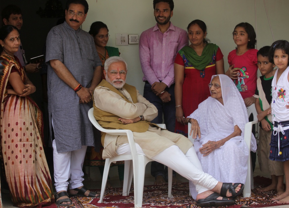 Opposition Bharatiya Janata Party leader Narendra Modi sits with his 90-year-old mother, Hiraben, during a visit to seek her blessings after preliminary results showed his party winning by a landslide, in Gandhinagar, in the western Indian state of Gujarat on Friday. Modi will be India’s next prime minister, winning the most decisive election victory the country has seen in more than a quarter century and sweeping the long-dominant Congress party from power, partial results showed Friday.