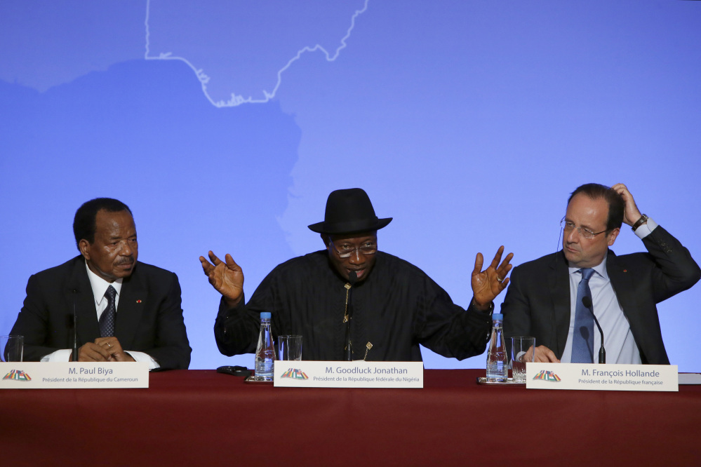 Nigeria President Goodluck Jonathan, center, answers reporters' questions. He is flanked by Cameroon President Paul Biya, left, and French President Francois Hollande during a news conference ending the “Paris Summit for Security in Nigeria" at the Elysee Palace on Saturday.