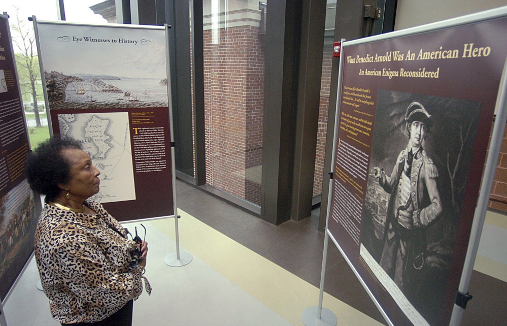 Lottie B. Scott, a member of the Norwich Historical Society, examines an exhibit on Revolutionary War Gen. Benedict Arnold at the Slater Memorial Museum in Norwich, Conn.