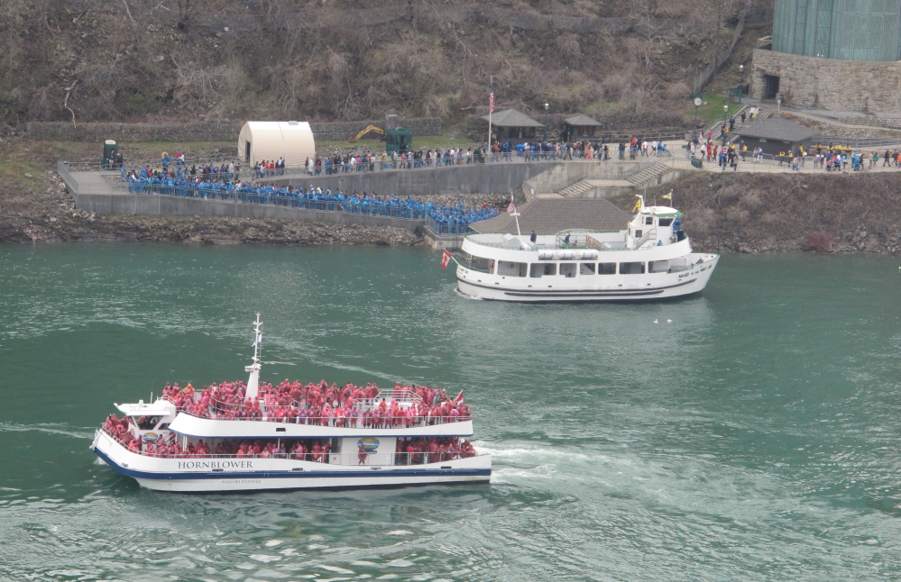 A Hornblower Niagara Cruises Catamaran, foreground, passes near a Maid of the Mist boat in Niagara Gorge last week. The Maid of the Mist Steamboat Co. continues to launch from the American shore but lost its Canadian contract.