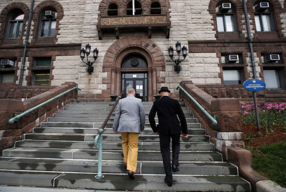 Scott Bechaz, left, and Carlos Franca walk up to Cambridge City Hall in Cambridge, Mass., on Friday to be married. The Republican Party platform defines marriage as “a union between a man and a woman” but attitudes may be changing.
