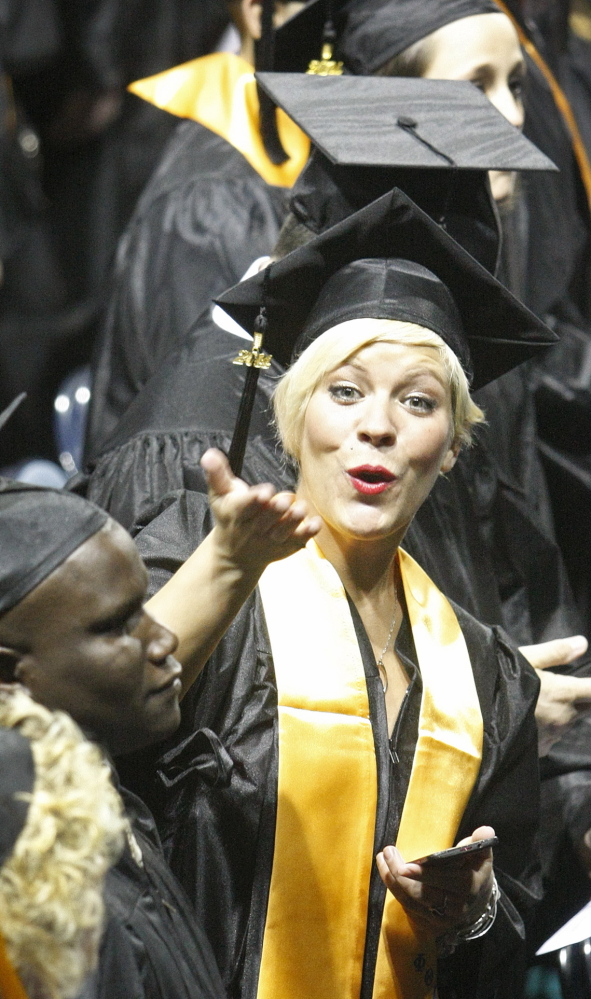 Jennifer Federico of Buxton blows a kiss to a friend as Southern Maine Community College graduates enter the Cumberland County Civic Center in Portland on Sunday for the school’s 67th graduation ceremony.
