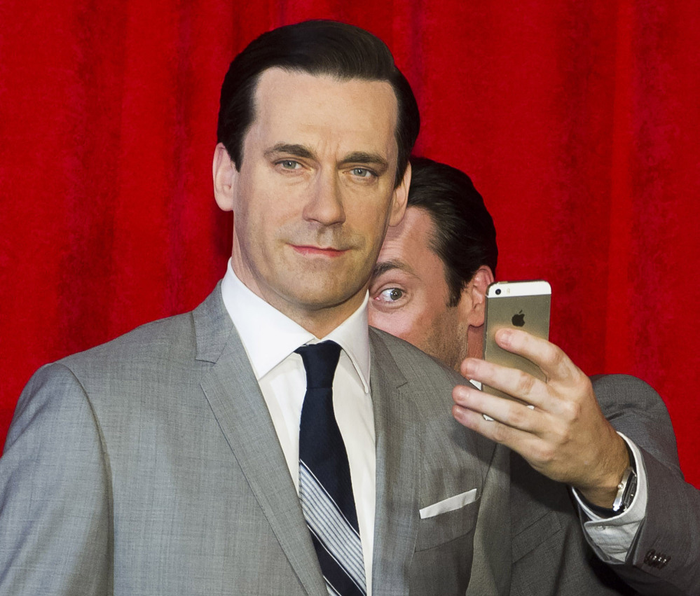 Actor Jon Hamm, the live one, takes a selfie at the unveiling of his wax figure at Madame Tussauds in New York. Selfie is one of the 150 new words appearing in Merriam-Webster’s Collegiate Dictionary.