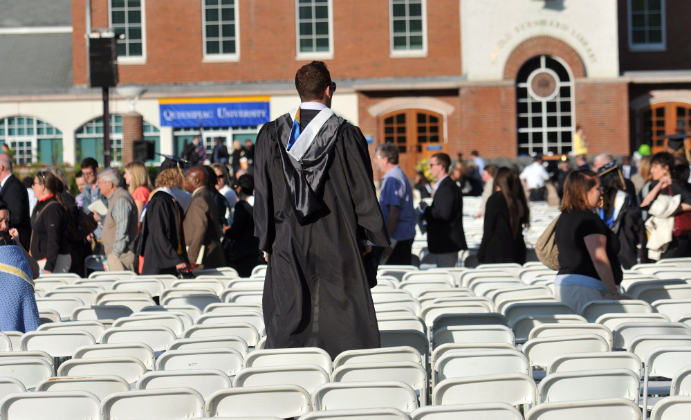 A Quinnipiac University graduate looks for relatives Sunday after university officials decided to move the graduation ceremony from the main campus because of bomb threats.