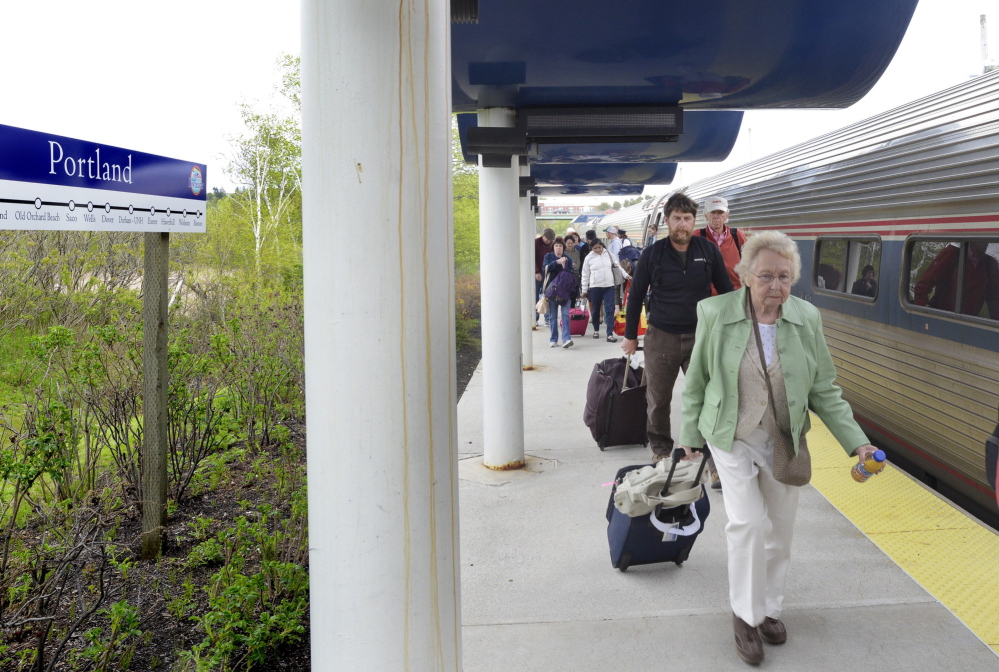Passengers arrive late aboard the Downeaster in Portland on Monday. “It doesn’t bother us one bit,” said Andrew Olson of Greenfield, who was picking up his son at the station. “It’s a wonderful ride and a great service.”