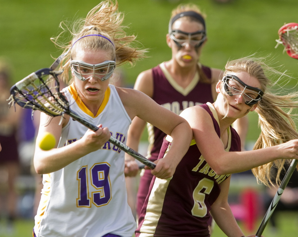 Anne Veroneau of Cheverus chases after the ball with Thornton Academy’s Julianna Grondin in Tuesday’s girls’ lacrosse game at Portland. Cheverus won, 9-6.