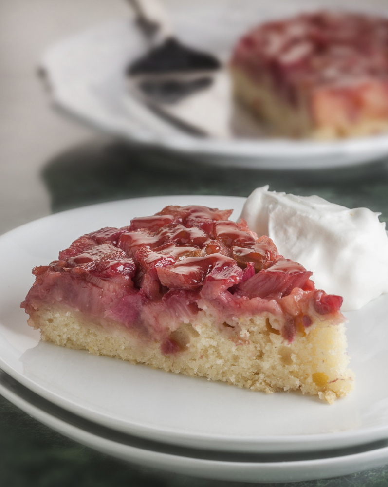 This upside-down cake is a good way to dispose of some of the rhubarb that’s shooting up now in home gardens.