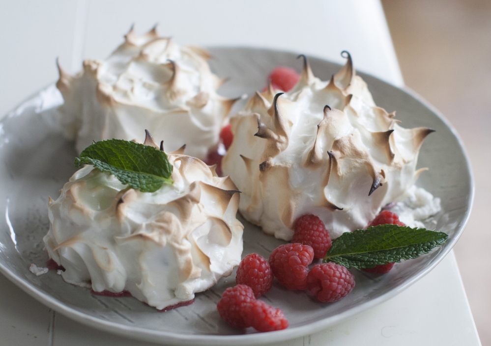 This version of baked Alaska features a classic meringue topping a brownie, with raspberry sorbet standing in for ice cream.