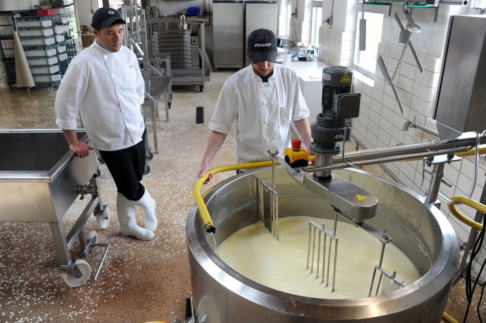 Kennedy and Hettlinger check on the cheese-making process, a constant requirement of their jobs.