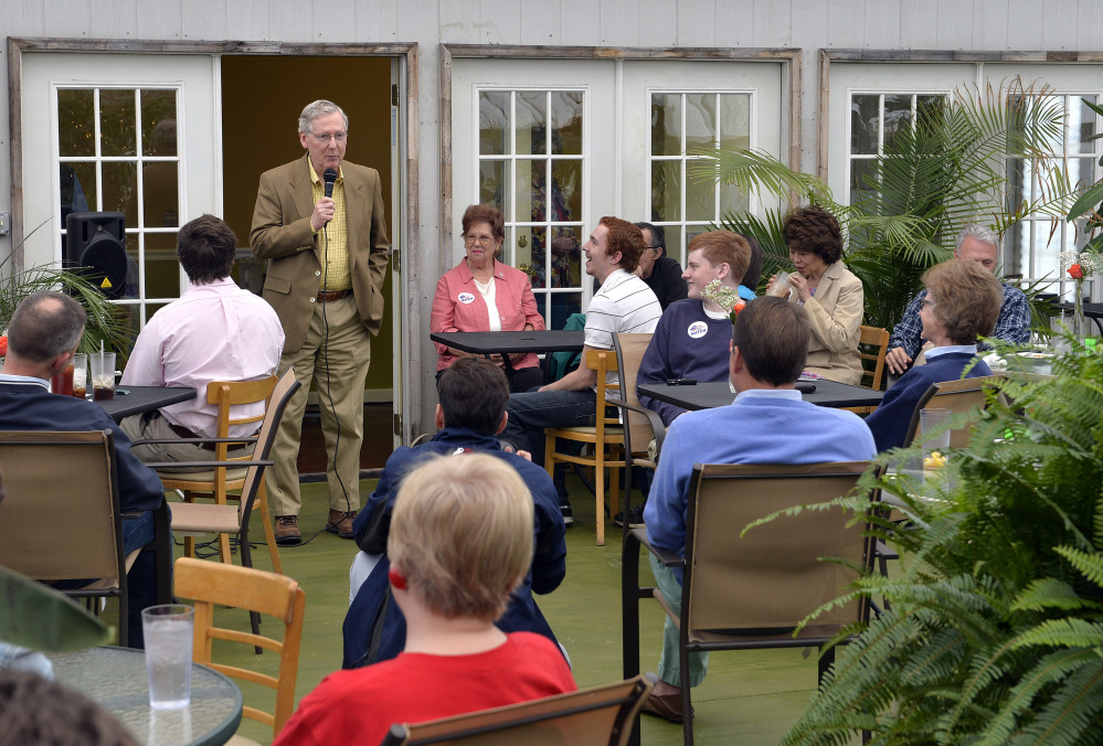 In this May 17, 2014, photo, Senate Republican leader Mitch McConnell speaks to a gathering of supporters at the Tanglewood Farms Restaurant in Franklin, Ky.