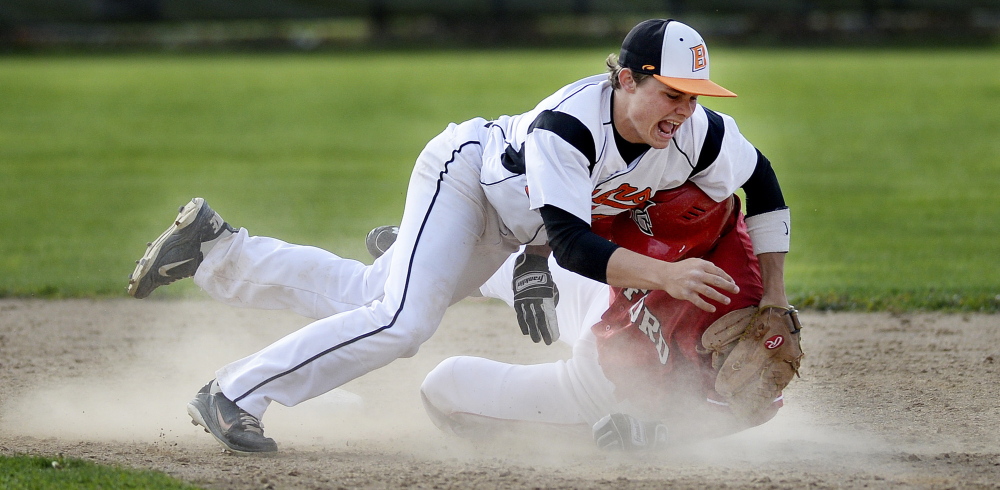 Biddeford’s Corey Creeger collides with Sanford’s Eddie Michetti during a play at second base Tuesday. Michetti was tagged out on the play.