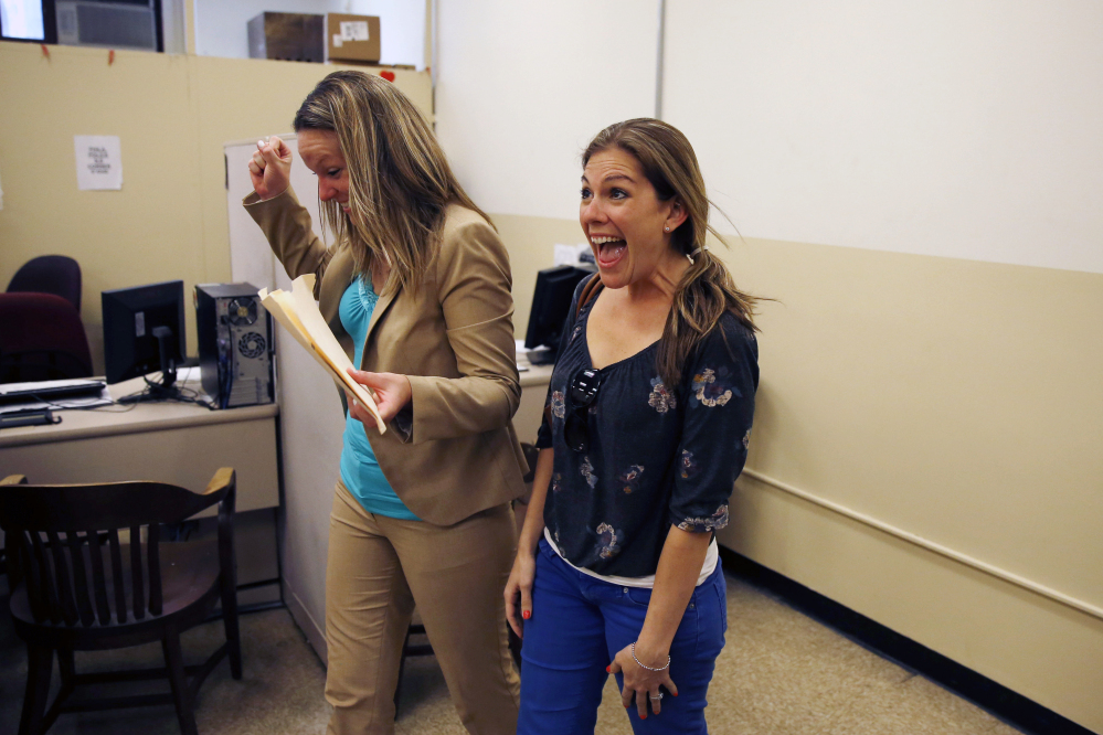 Ashley Wilson, left, and Lindsay Vandermay, right, react after getting their marriage license at the Philadelphia Marriage Bureau in City Hall on Tuesday.