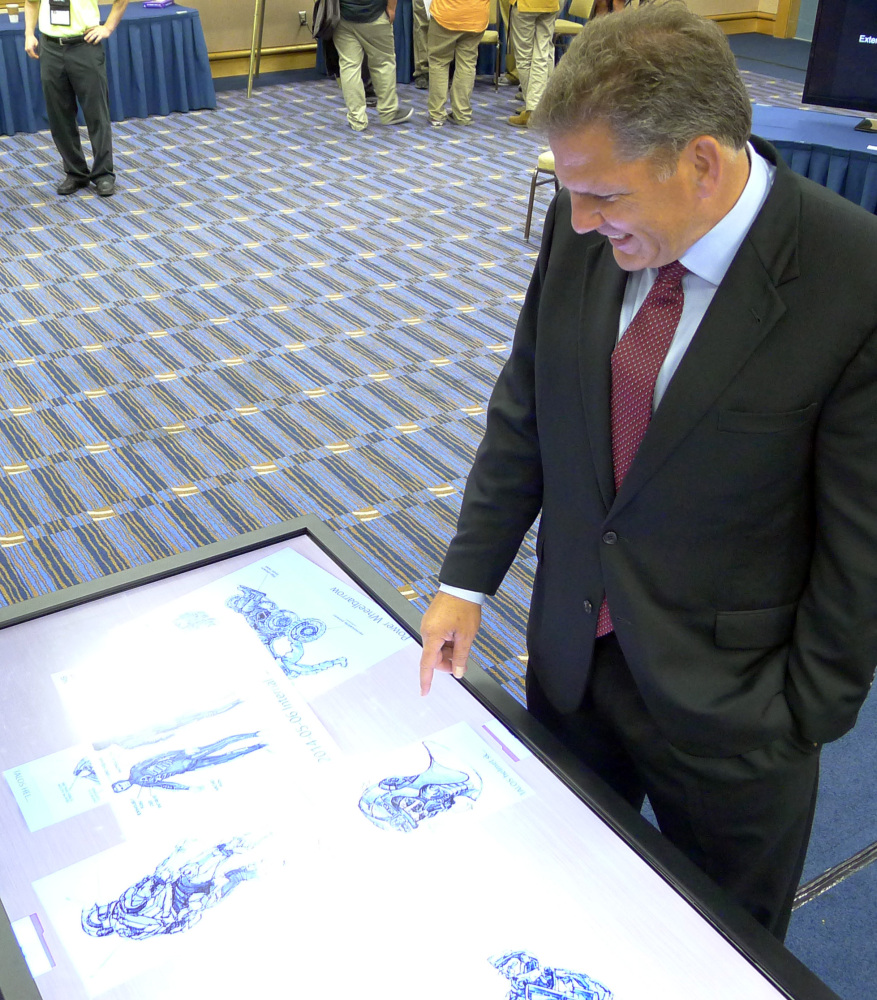James Geurts, deputy for acquisition of the U.S. Special Operations Command at MacDill Airforce Base, looks at sketches of the Tactical Assault Light Operator Suit during the Special Operations Forces Industry Conference in Tampa, Fla., on Monday.