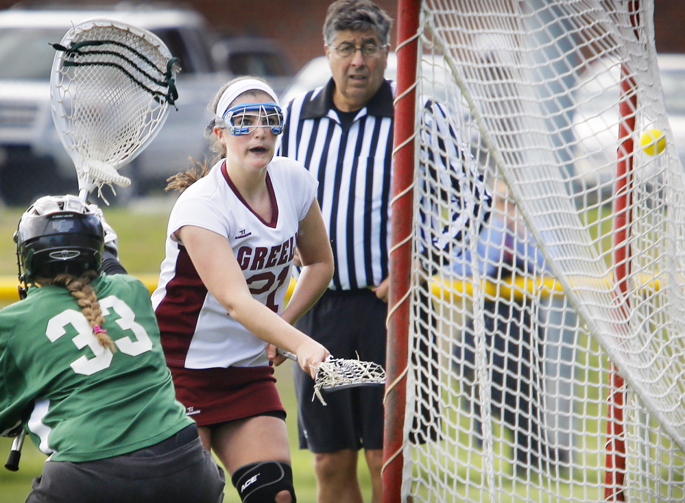 Gabby Bouchard of Greely gets the ball past Waynflete goaltender Charlotte Majercik to score a first-half goal. Waynflete scored twice near the end of the half to make it 4-4 at the break.