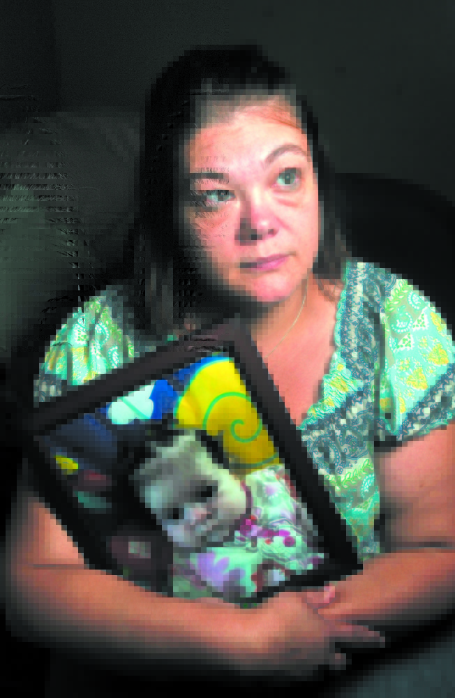 Time of mourning: Nicole Greenaway holds a picture of her daughter Brooklyn Foss-Greenaway at her home in Clinton. Her 3-month-old baby died while in the care of a friend July 8.