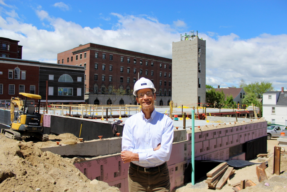John Ryan visits a Wright-Ryan Construction housing project at 409 Cumberland Ave. in Portland. The firm is known for its environmentally friendly business practices.