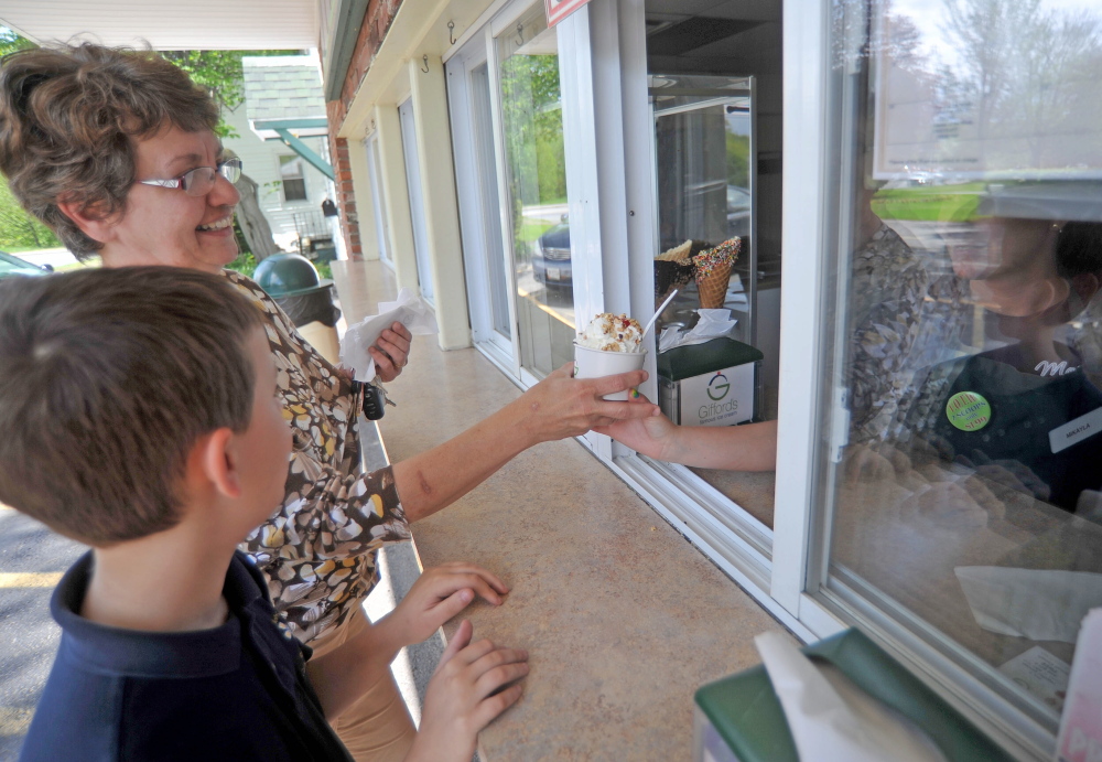 Marge Veilleux and her grandson Nolan, 9, order ice cream at Gifford’s Ice Cream on Silver Street in Waterville on Thursday afternoon. The Maine-owned company will be selling its products in the Washington, D.C., area soon.