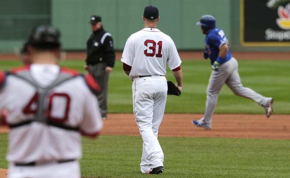 Boston Red Sox starting pitcher Jon Lester (31) watches Toronto Blue Jays’ Melky Cabrera, right, round the bases on a solo home run during the first inning of a baseball game at Fenway Park, Thursday, May 22, 2014, in Boston.