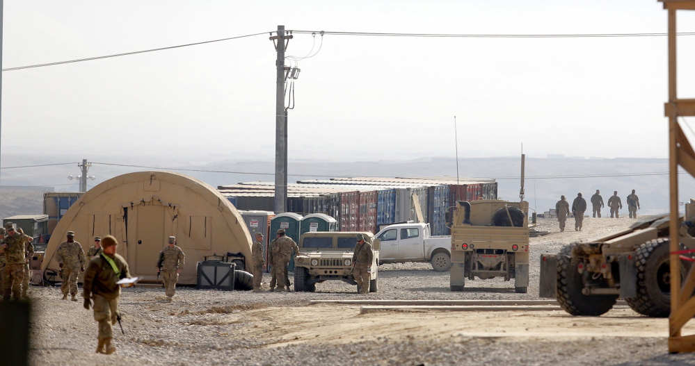 Soldiers work near the headquarters of the 133rd Engineer Battalion of the Maine Army National Guard last year at Bagram Airfield in Afghanistan.