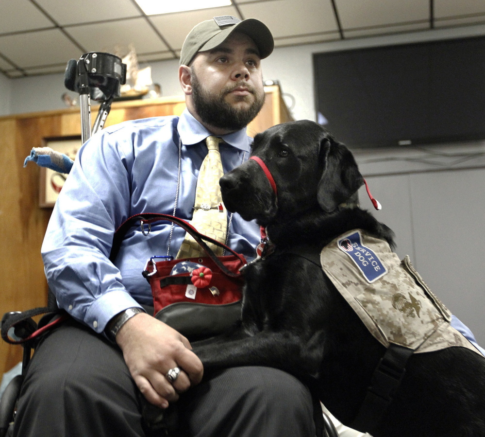 Former U.S. Marine Ryan Bugler and his Labrador retriever service dog, Noonan, attend a ceremony at the Oakville VFW Post 7330 in Watertown, Conn.