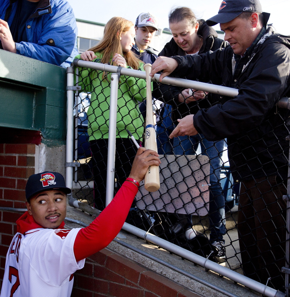 Mookie Betts, handing an autographed bat back to Jon Barton of Sanbornville, New Hampshire, has been a sensation with the Sea Dogs and may get a promotion to Triple-A sooner rather than later.