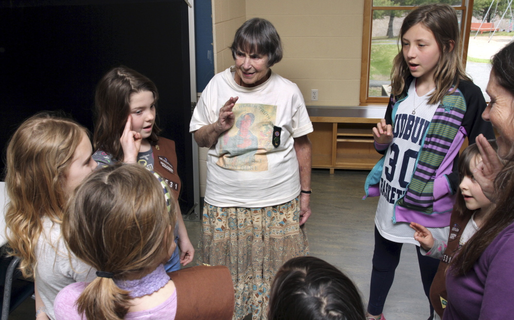 Molly Robinson, center, recites the Girl Scout Promise during a meeting with her troop in Greenfield, Mass. Robinson still projects a vitality and sense of leadership that is not diminished by her use of a walker or wheelchair.